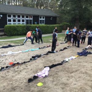 clothes lines up in rows that students are using to participate in a game
