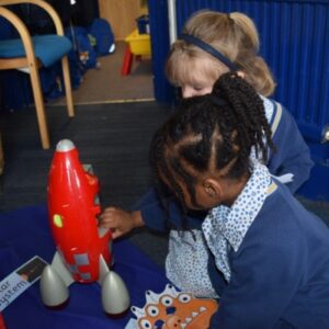 children working with a plastic rocket