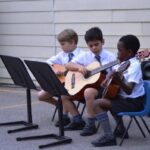 Students playing the guitar