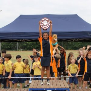 Student with trophy in the air