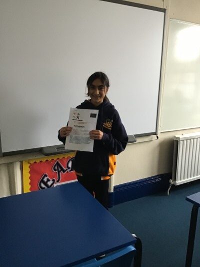 student holding up a presentation sheet