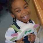 girl with a dinosaur creation