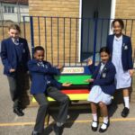 students by a buddy bench