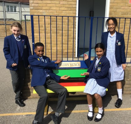 students by a buddy bench