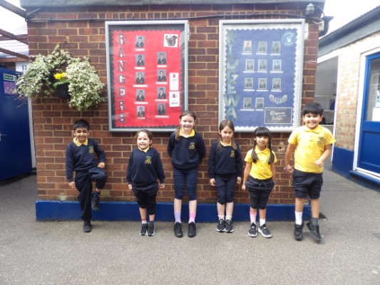 young students leaning on a wall