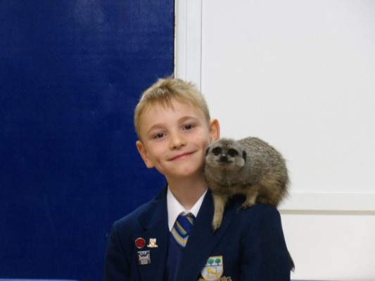 student with an animal on his shoulder