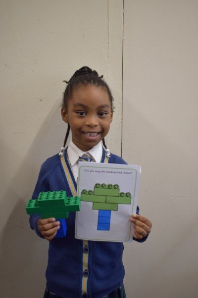 young student showing off her lego recreation