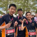 students holding their medals after a marathon