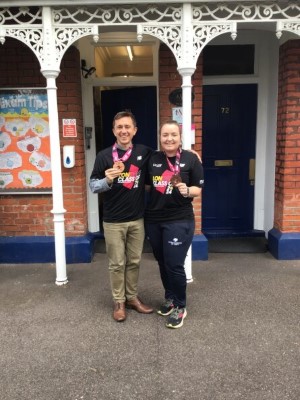 mand and woman holding their medals