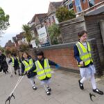 students picking up litter on the street