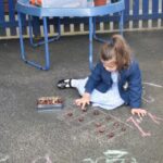 pre prep student drawing on the floor with chalk