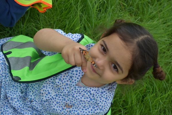 student holding a butterfly