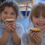 students holding tea cakes