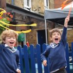students waving diwali decor