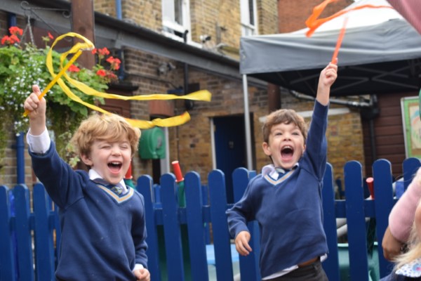 students waving diwali decor