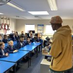 students listening to a man