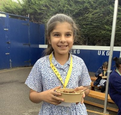 girl holding a bowl of food