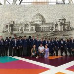 students in front of a big picture